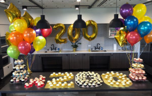 200 employee celebration with cupcakes and balloons